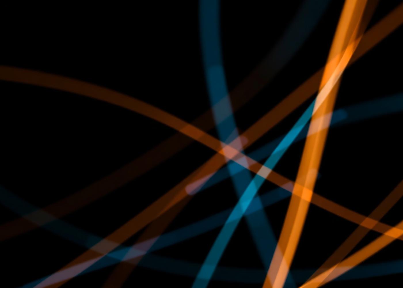 Long exposure light streaks in amber and blue on a dark background
